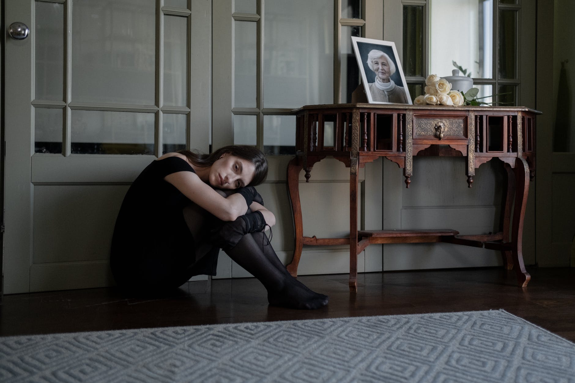 an emotional woman sitting on the floor